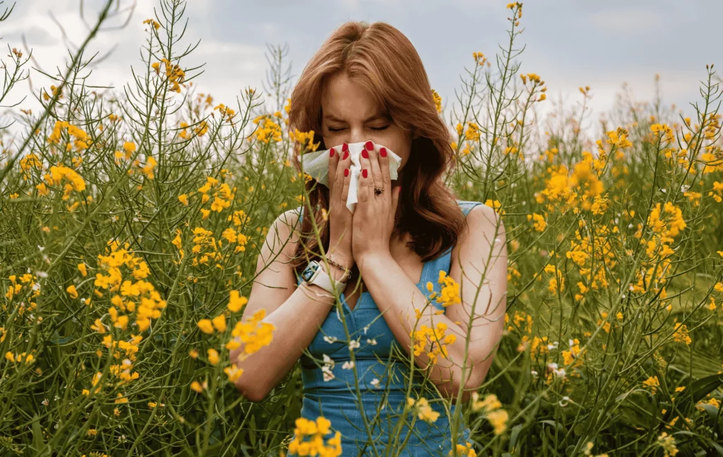 Une jeune femme dans un champs, allergique aux pollens et graminées.